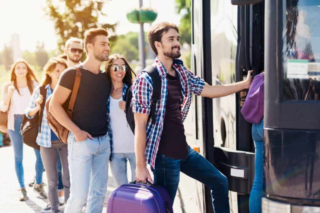 A,Group,Of,Tourists,Preparing,To,Get,On,The,Bus.